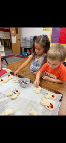 Children shaping bunny dough together
