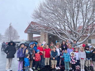 Student group photo in first snow of the season