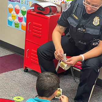 Student getting a sticker from an officer