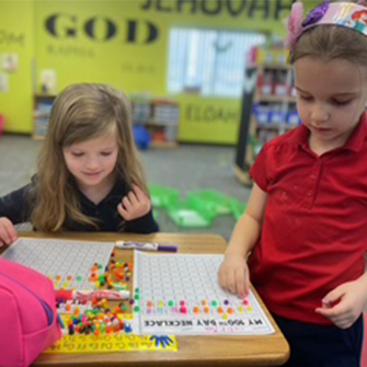Elementary girls working together at a desk