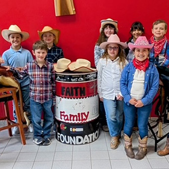 Children dressed in cowboy hats and clothes during Western Day