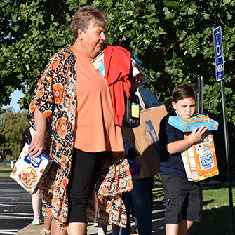 Woman and child carrying boxes of food