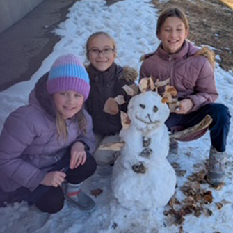 Students making a snowman